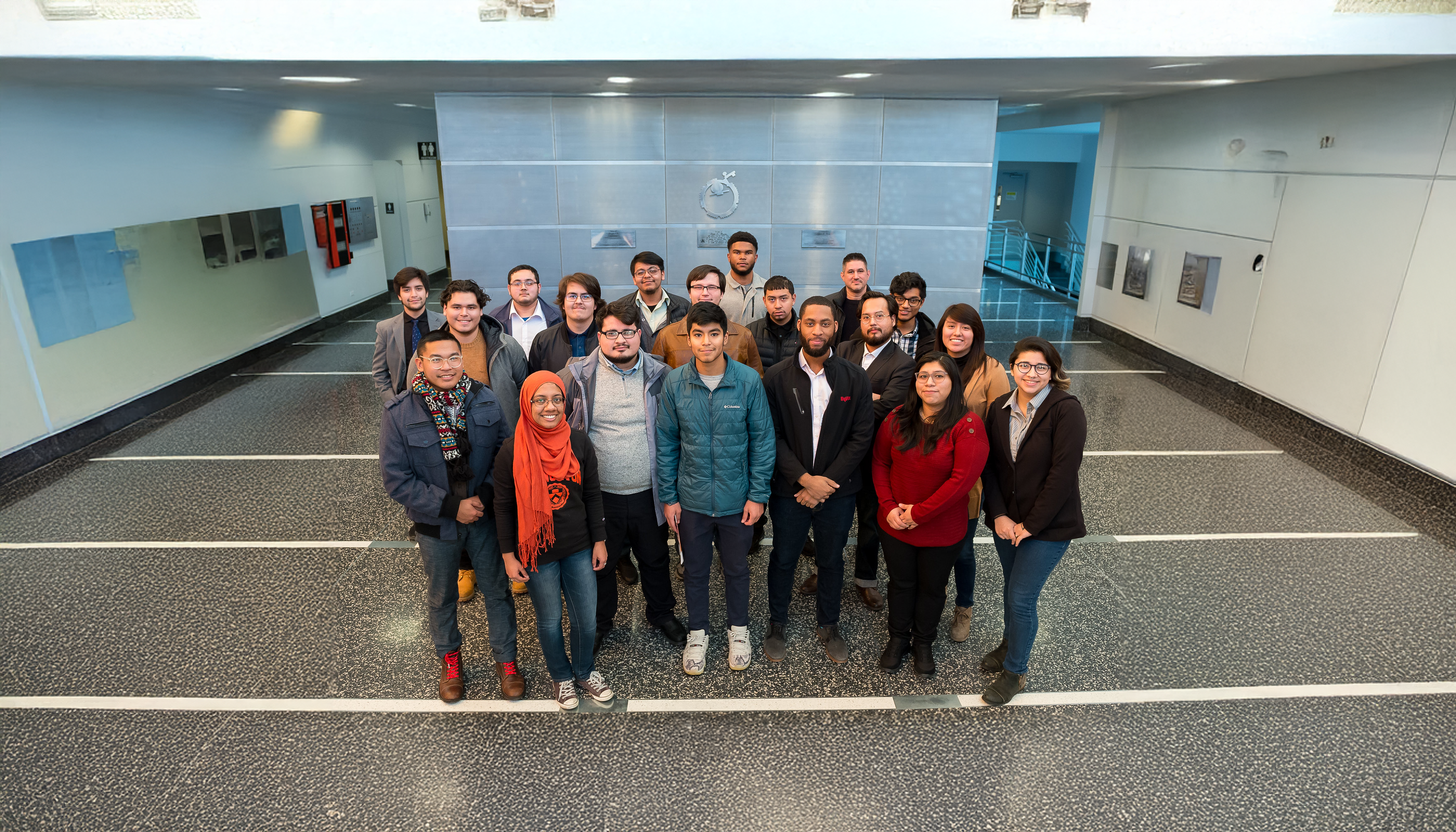 A group of Argonne employees standing together, smiling, and looking toward the camera.